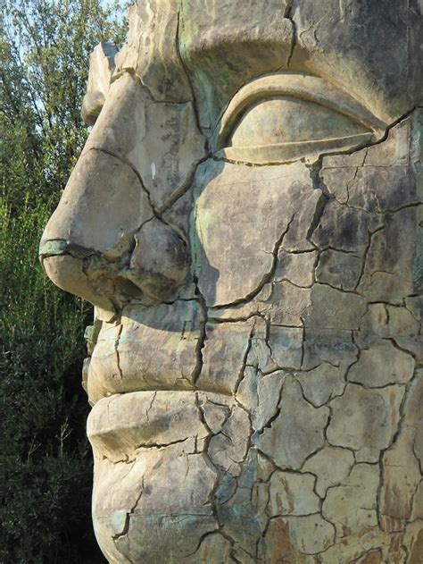 Giant Cracked Face Statue Depicts Strength And Fragility