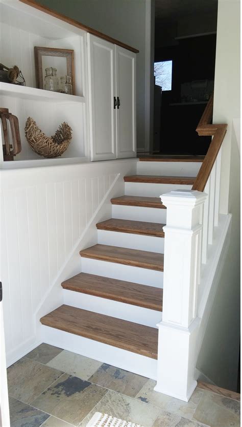 This place has laminate flooring at stairs with raised stair nosing installed. DIY split entry remodel, added storage, planking to tie ...