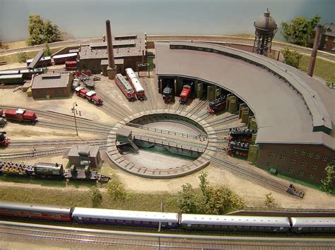 A Model Train Station With Trains On The Tracks