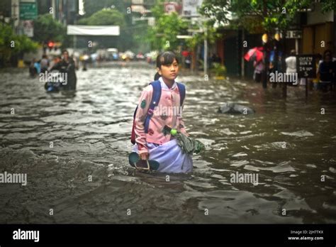 A Student Walking Through A Flooded Street In Central Jakarta After A