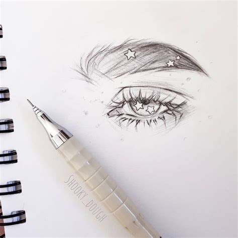 A Pencil Drawing Of An Eye With Stars On It