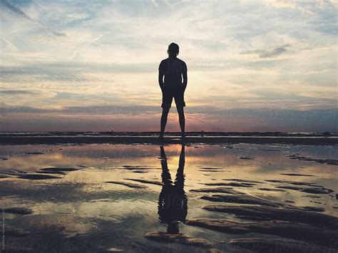 Man Watching A Sunset At The Beach By Stocksy Contributor Eva