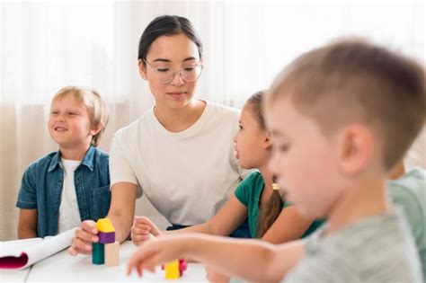 What online games can i play on the computer during school? Woman teaching kids how to play with colorful game during ...