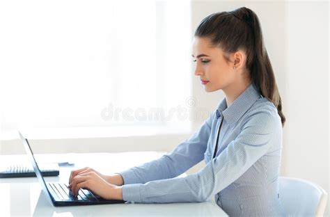 Young Beautiful Business Woman Working On Laptop In The Office Stock