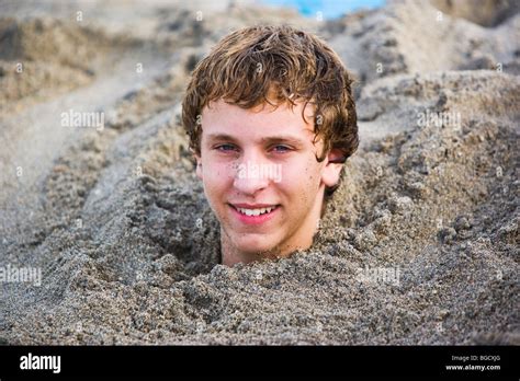 Teen Boy Buried In Sand On The Beach Smiling Portrait Hollywood