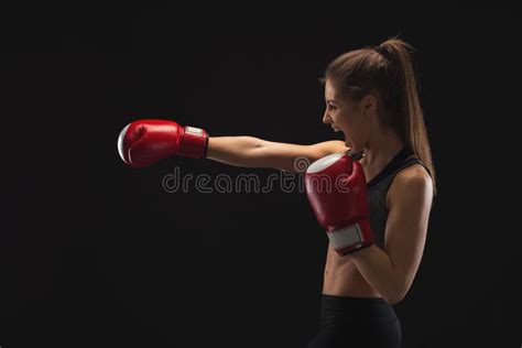 Side View Of Emotional Young Woman With Boxing Gloves Stock Photo