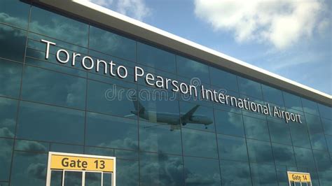 Landing Airplane Reflects In The Modern Windows With Toronto Pearson
