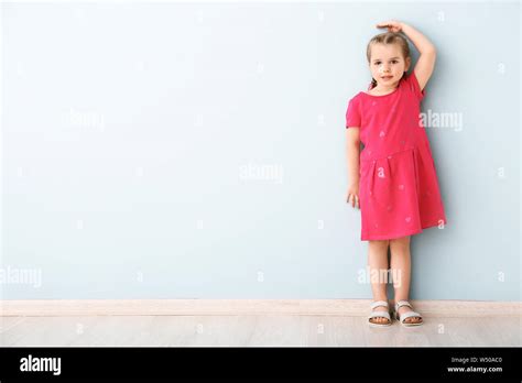 Little Girl Measuring Height Near Wall Stock Photo Alamy