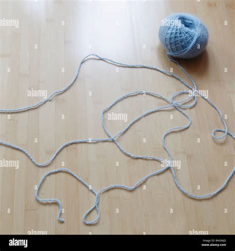 Ball of yarn unraveling Stock Photo - Alamy
