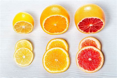 Top View Orange Lemon And Grapefruit Juices With Slices Of Fresh