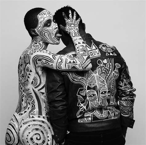 Two Men With Tattoos On Their Body Hugging Each Other