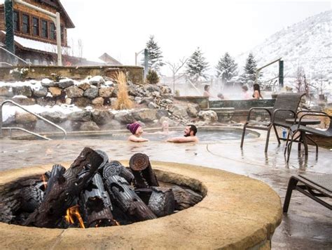 Two People In A Hot Tub Surrounded By Snow