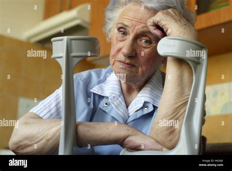 senior sit crutches rest on sadly thoughtful detail 60 70 years woman old old person