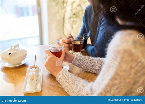 Close Up Of Couple Drinking Tea At Cafe Stock Image Image Of Table