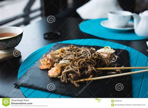Buckwheat Noodles With Shrimps And Shavings Of Tuna With Sauce On Black