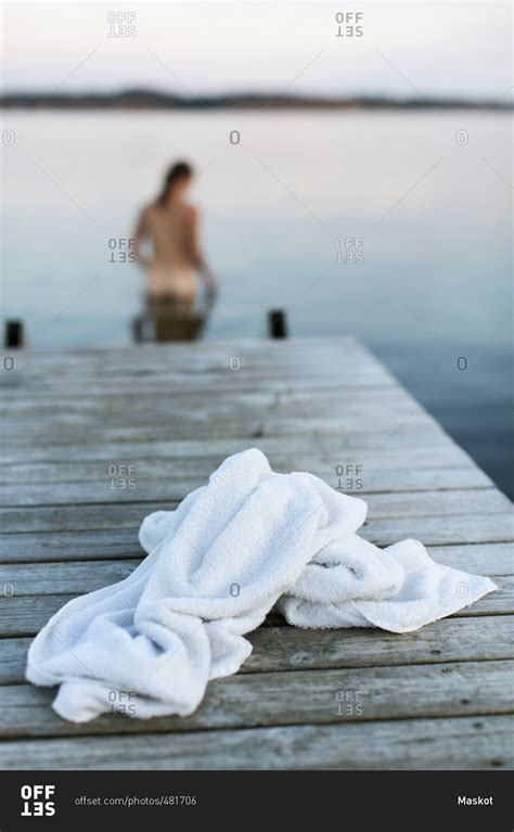 White Towel On Jetty With Naked Woman In Lake Stock Photo Offset