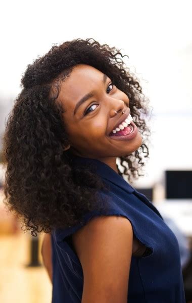 Black Woman Smiling In An Office Positive Routines