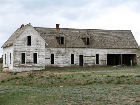 Old Abandoned Rural Farm House With White Chipped Paint Abandoned