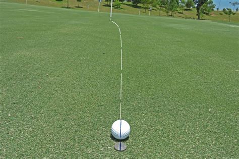 Marking the golf ball and guessing your line. How to Putt a Golf Ball Step by Step Properly - Golf Sidekick