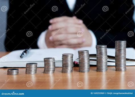 Accountant Verify The Business And Saving Money Stacking Gold Coins