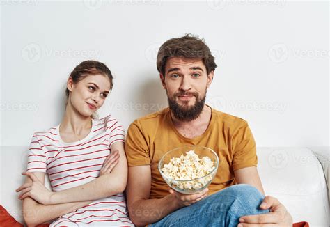 Man And Woman On The Couch With Popcorn Watching Tv Shows 21989308