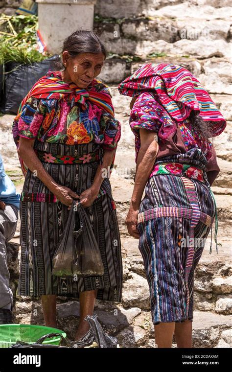 Two Quiche Mayan Woman In Traditional Dress Visit In The Market On The