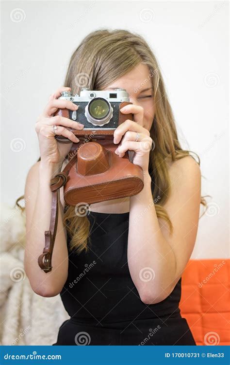 Young Woman Holds A Retro Camera In Her Hands Stock Image Image Of