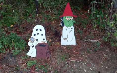 Charlie Brown In His Ghost Costume And Lucy In Her Witch