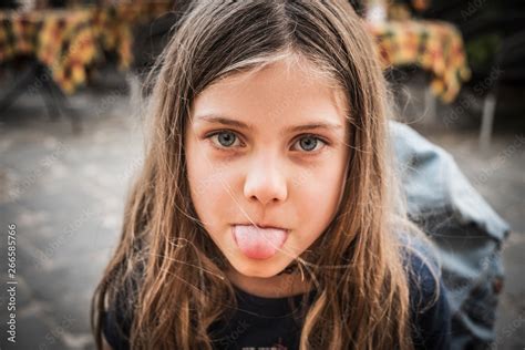 Portrait Of A Babe Girl With Tongue Sticking Out Stock Photo Adobe Stock