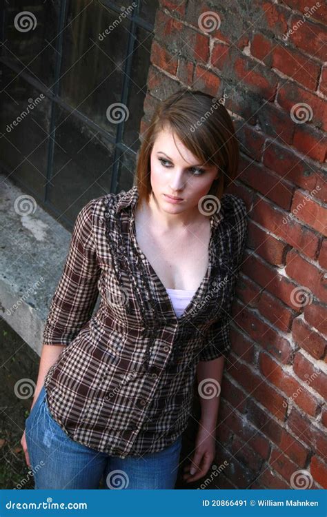 Young Woman Leaning Against Brick Wall Stock Image Image Of Eyes