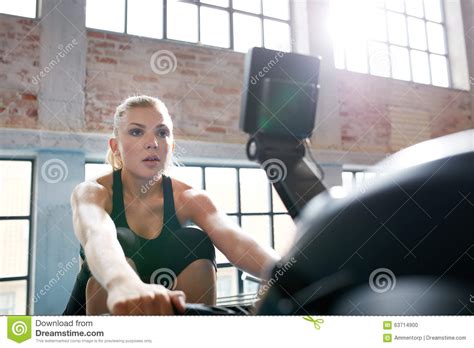 Female Working Out On A Treadmill At Gym Stock Photo