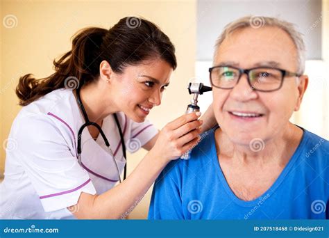 Doctor Using Otoscope To Check On Elder Mans Ear Stock Photo Image Of