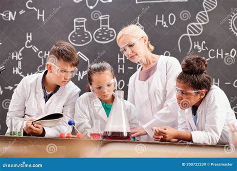 Several Students Of Secondary School And Teacher Making Chemical