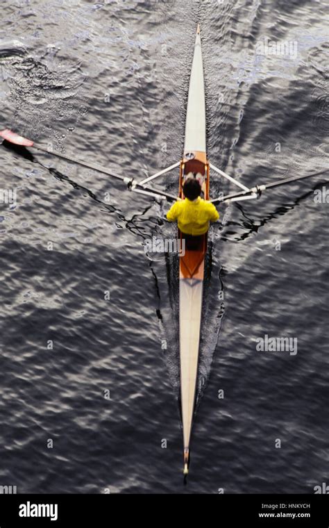 A Man Sculling In A Single Scull Rowing Boat On The Water Overhead
