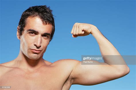 Man Flexing Biceps High Res Stock Photo Getty Images