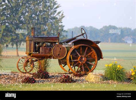 A Rusty Vintage Farm Tractor On Display In A Rural Farm With Bright