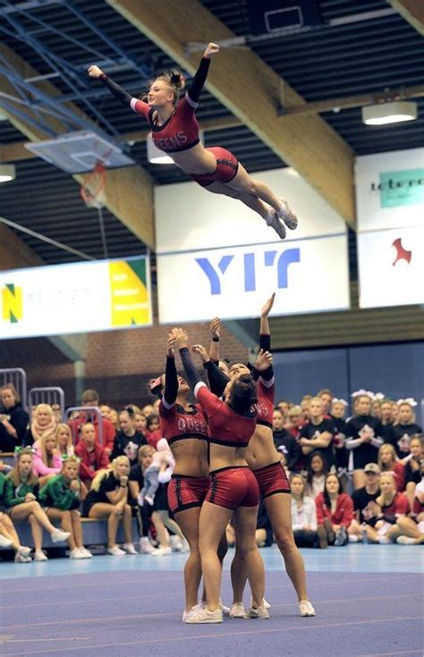 The Athletes Cheer In The Air Competitive Cheerleading Stunt
