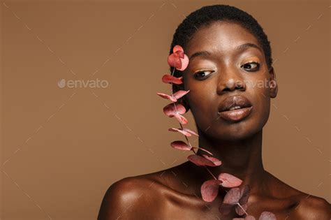 Beauty Portrait Of Young Half Naked African Woman Holding Exotic Flower