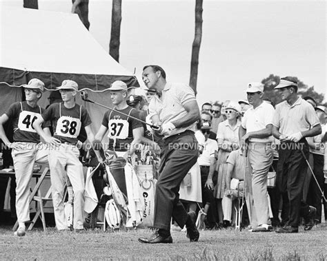An Old Black And White Photo Of A Man Playing Golf In Front Of A Crowd