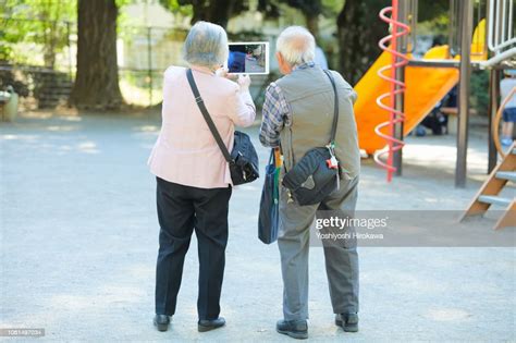 Smiling Smartphone Seniors Who Take Self With Smartphone While Standing