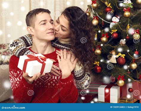 Happy Couple Kiss In Christmas Decoration At Home New Year Eve