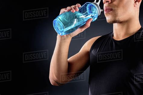 Cropped Shot Of African American Sportsman Drinking Water On Black