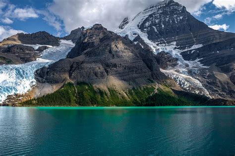 Berg Lake Sitting Under The Tallest Peak In The Canadian Rockies Mt