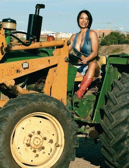 A Woman Sitting On The Back Of A Tractor