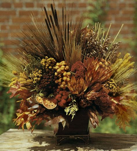 Dried flowers are now the most popular choice for throwing at weddings. Fall Centerpiece #Dried Flower Arrangement. Knud Nielsen ...