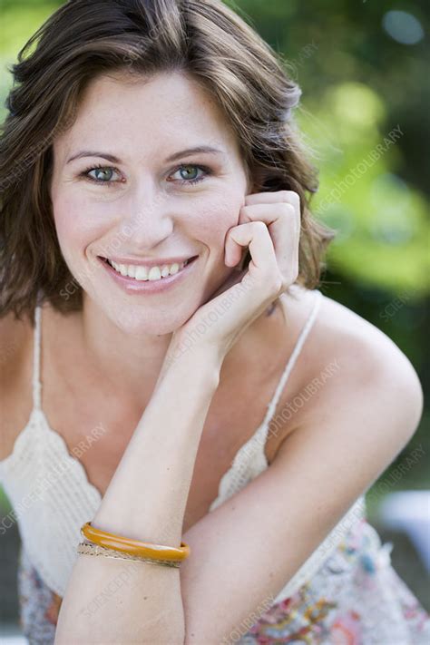 Smiling Woman Sitting Outdoors Stock Image F Science Photo Library