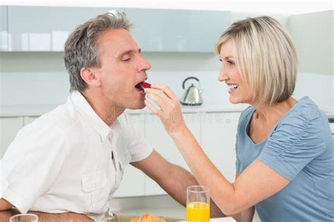 Loving Woman Feeding Man In The Kitchen Stock Image Image Of