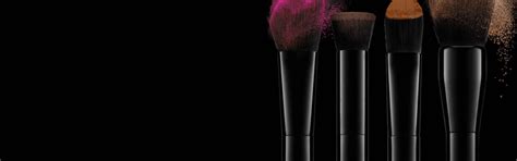 Brushes With Coloured Make Up On A Dark Background
