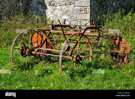 Rusty Farm Machinery In Corner Of Field Stock Photo Alamy