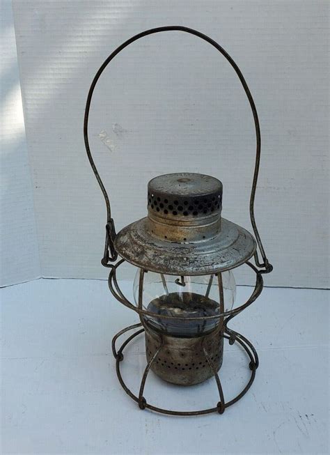 an old fashioned metal lantern with two pots inside